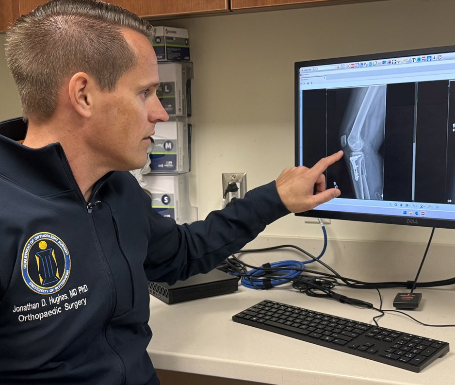 Dr. Hughes reviewing knee imaging with a patient in clinic