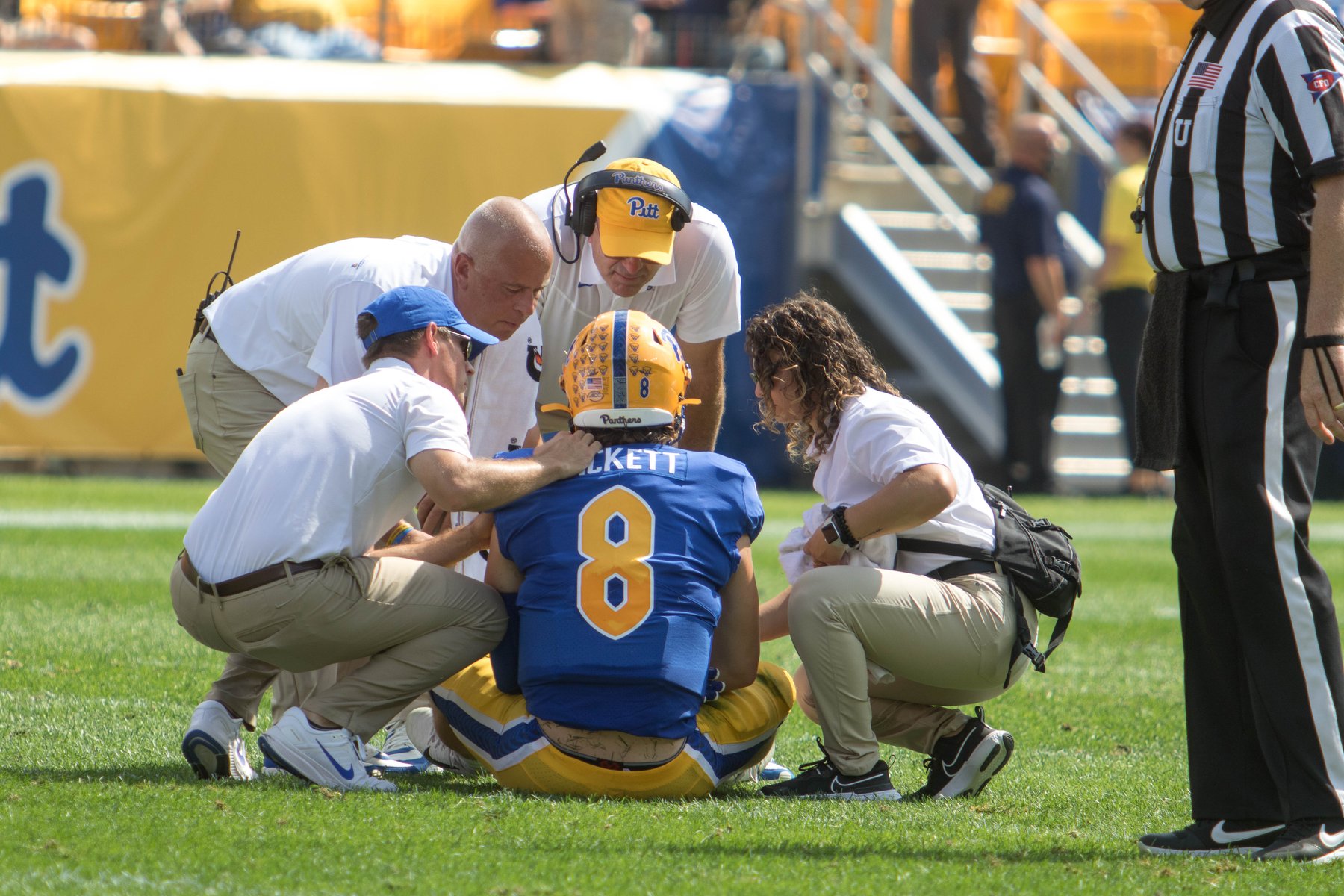 Dr. Hughes providing sideline injury care during a college football game